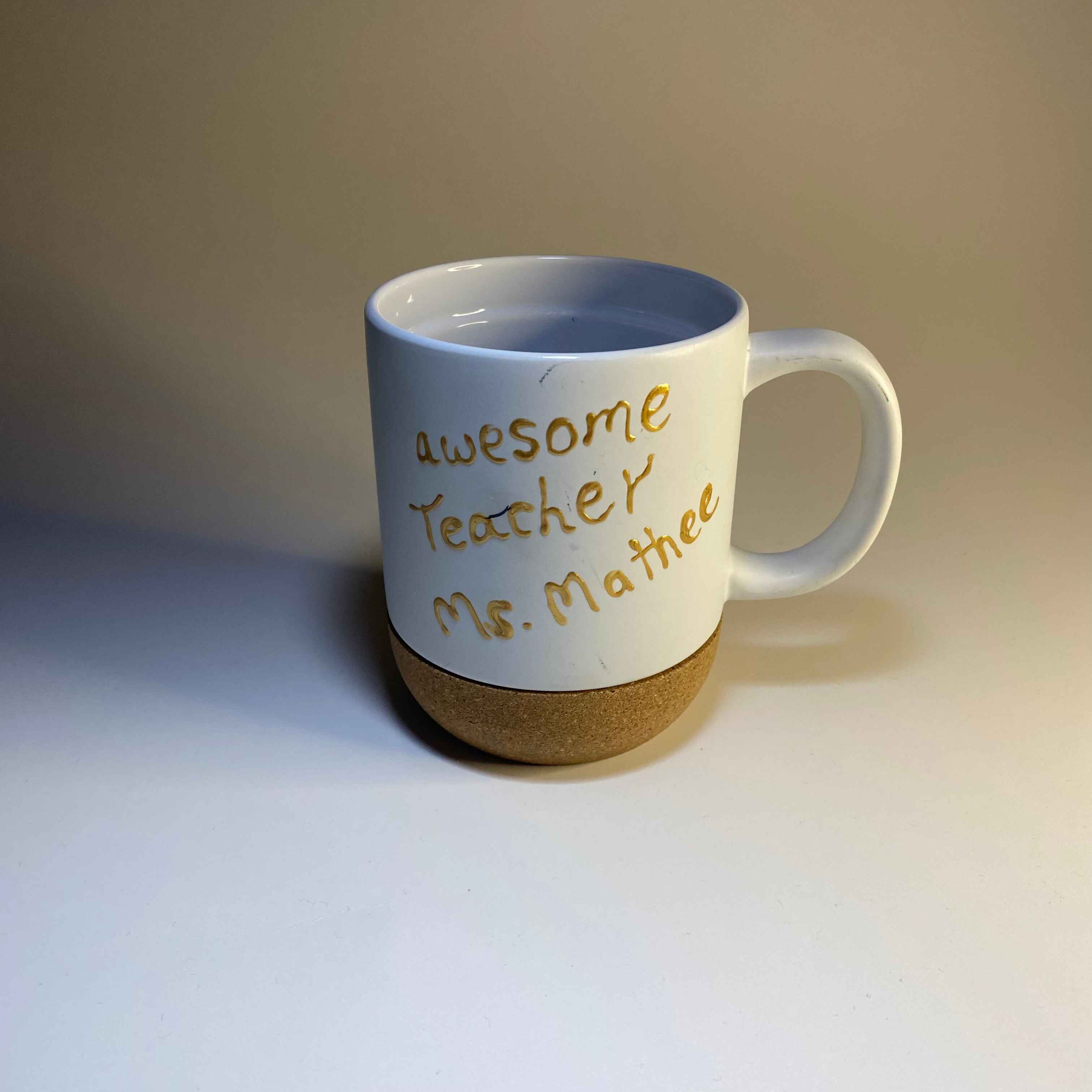 Front view of my sister's coffee mug, with the handle on its side